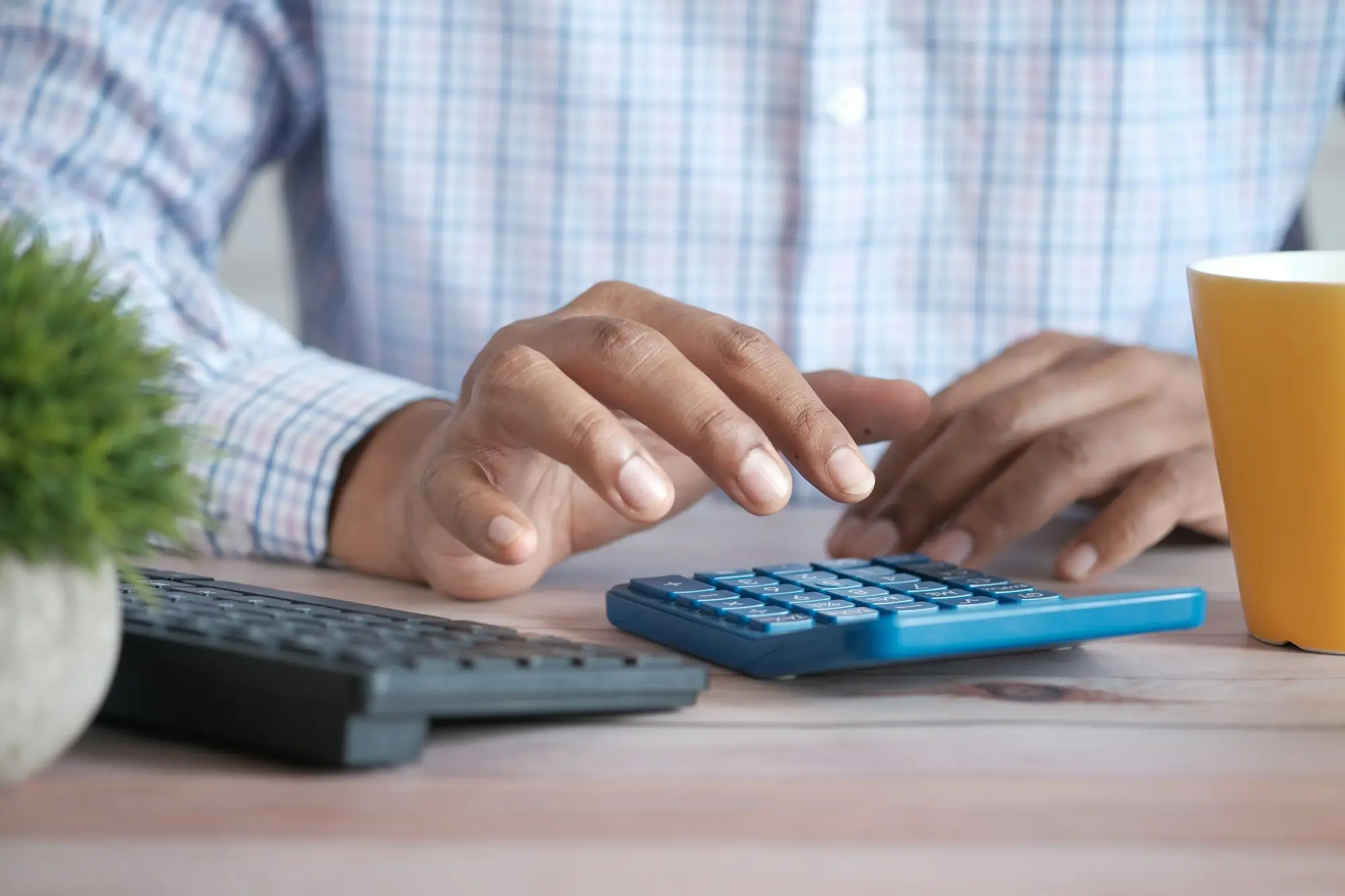 BAS paperwork, a calculator and a notepad spread across a desk during a tax catch-up