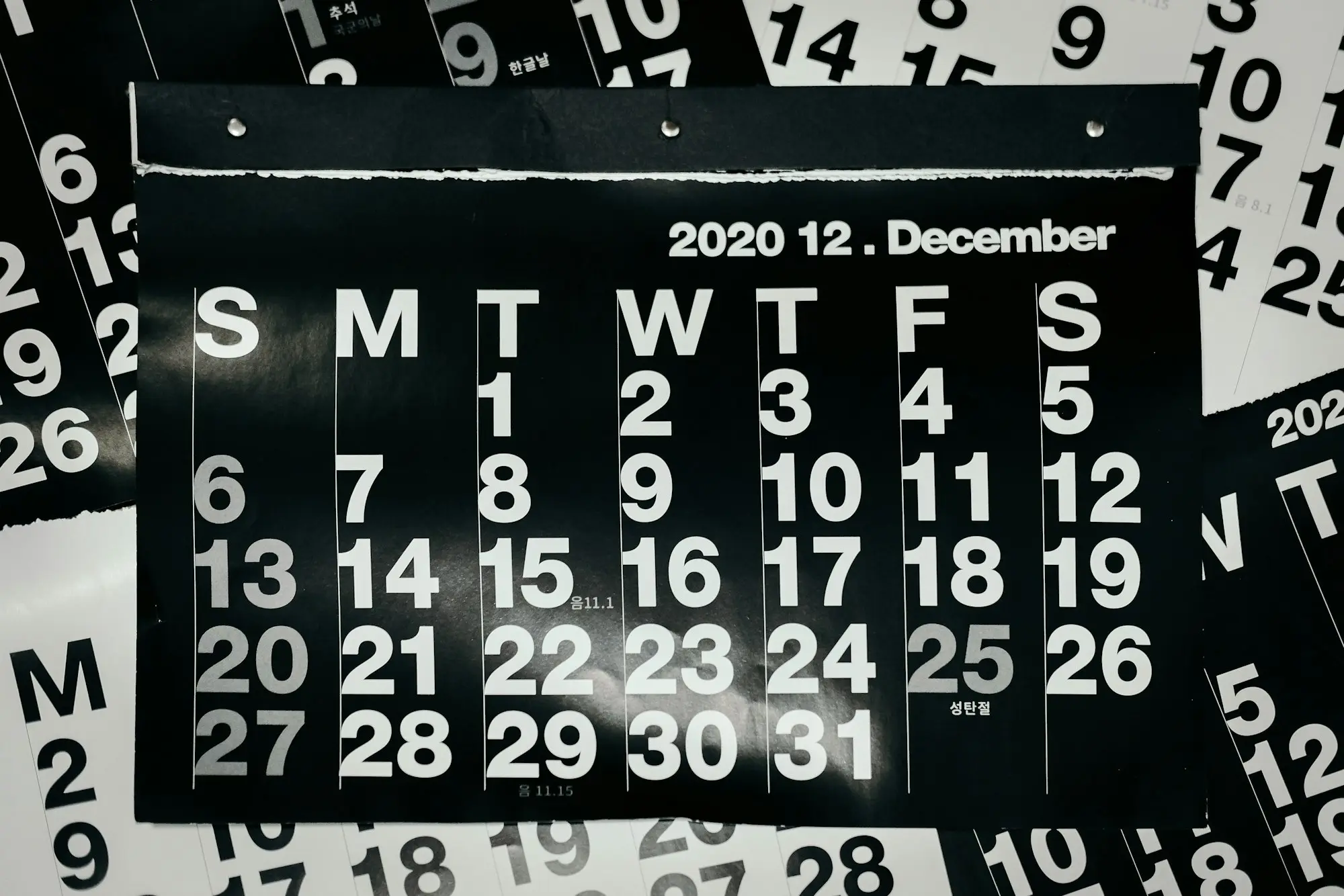 Wall planner calendar with handwritten notes in a small Brisbane business office
