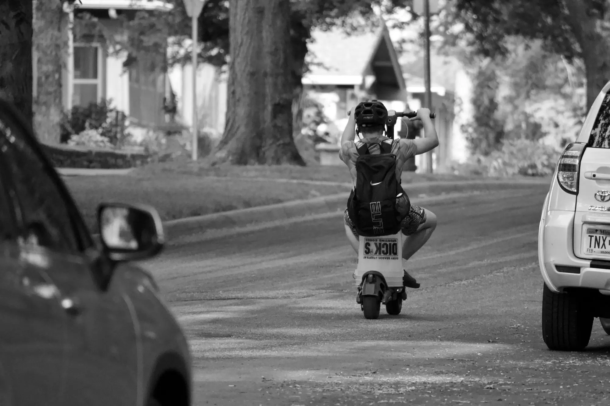 Business owner walking along a leafy Australian suburban street while thinking through a phone call