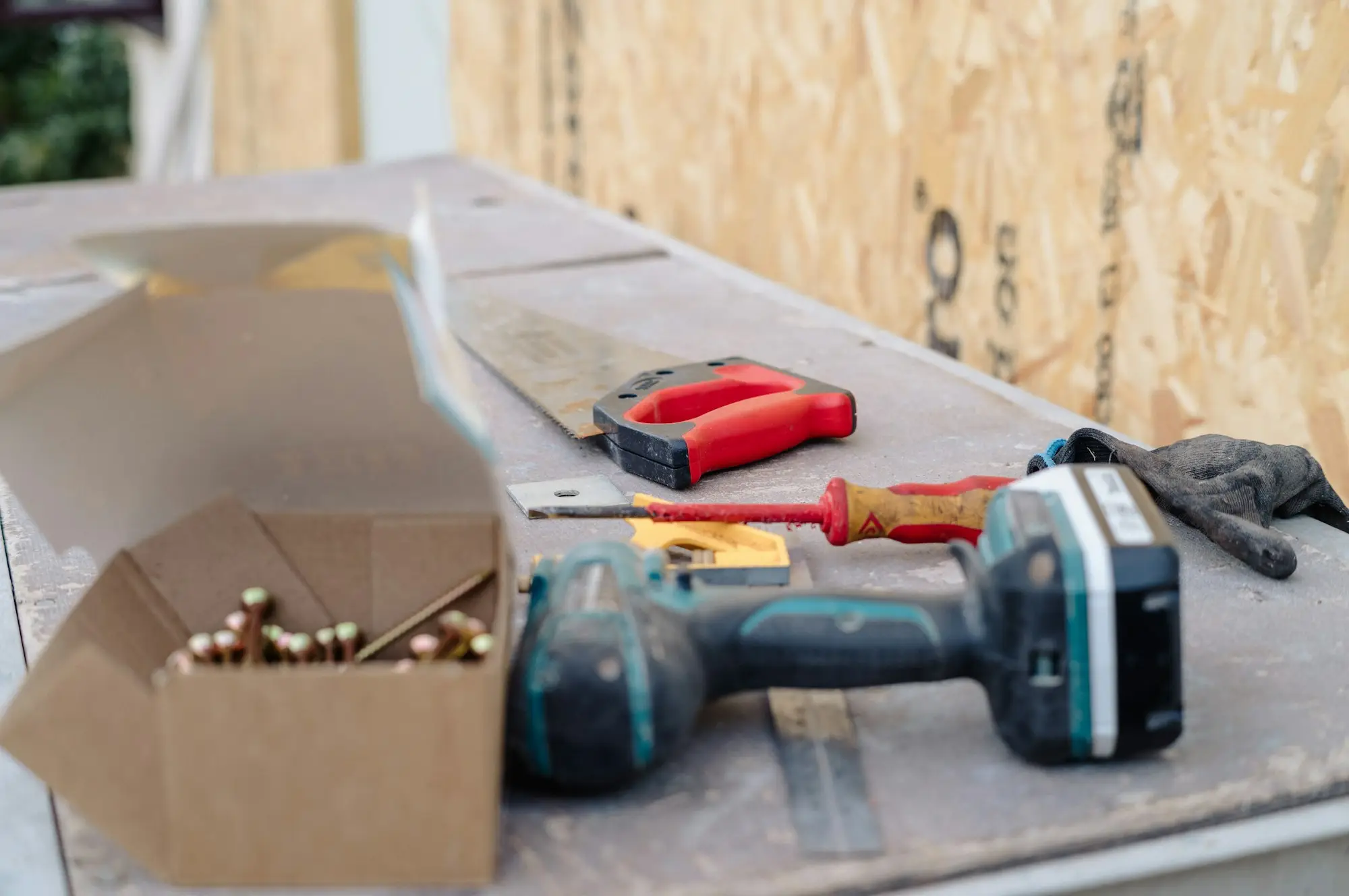 Tradesperson loading tools into a ute parked in a driveway in regional Victoria